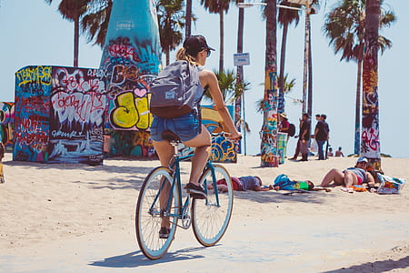 woman riding bicycle near beach thumbnail