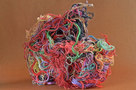 assorted-color threads on brown surface thumbnail