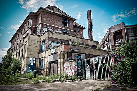 brown concrete building under blue and white sky thumbnail