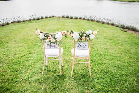 two white chairs on green grass during daytime thumbnail