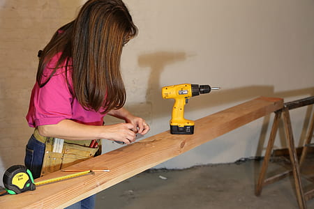 person near yellow and black cordless power drill thumbnail