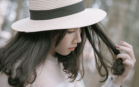 Woman Wearing White and Black Hat thumbnail