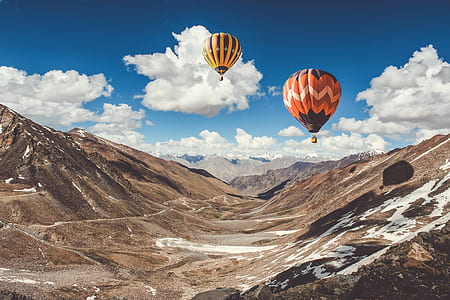 two red and yellow hot air balloons in the sky thumbnail