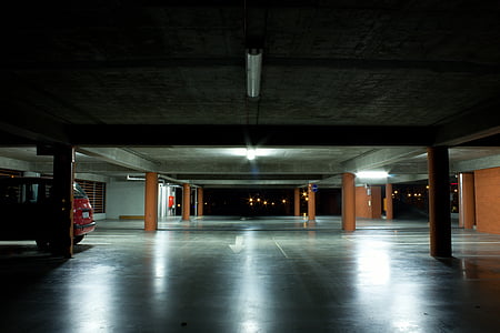 red vehicle parked at garage during night time thumbnail