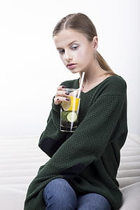 woman drinking soda sitting on mattress thumbnail
