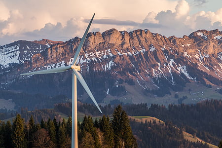 white windmill under cloudy sky thumbnail