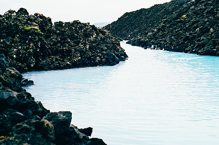 body of water and rocks photo thumbnail