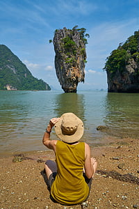 person sitting near body of water thumbnail