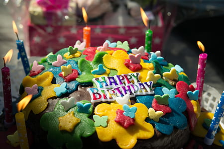 black, yellow, blue, and red icing-coated cake thumbnail