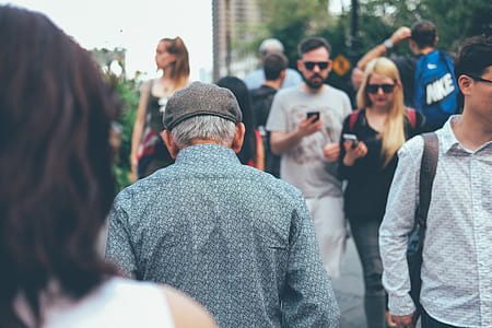 shallow focus photography of man walking outdoors thumbnail