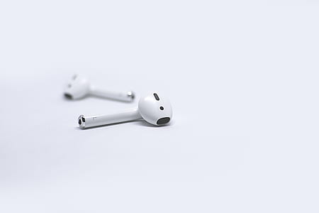 Apple AirPods on white surface thumbnail