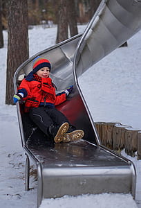 boy sliding on silver slide thumbnail