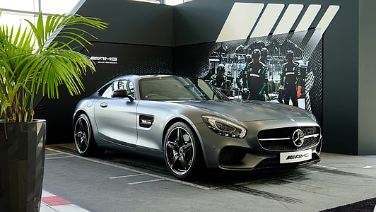 silver Mercedes-Benz AMG GT inside auto show room thumbnail