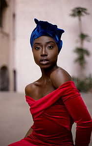 selective focus photography of woman wearing red off-shoulder long-sleeved shirt thumbnail
