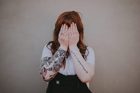 woman covering her face with both hands thumbnail