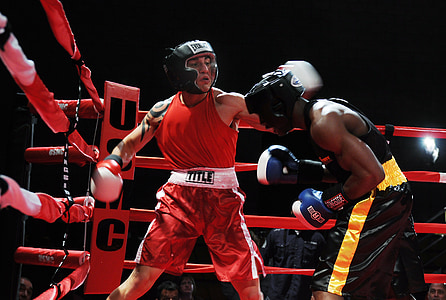 two men boxing on the ring surrounded by people thumbnail