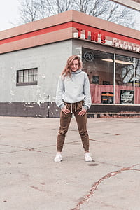 woman with hands on pockets standing in front of Tim's Radiator building thumbnail