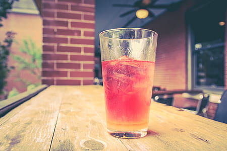 clear beverage glass with red beverage in rocks thumbnail