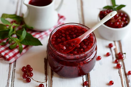glass jar filled with red berry jam with spoon thumbnail