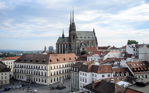 gray cathedral surrounded by houses thumbnail
