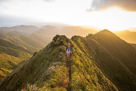 woman walking on mountain trail thumbnail