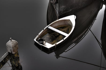 white jon boat on calm body of water thumbnail