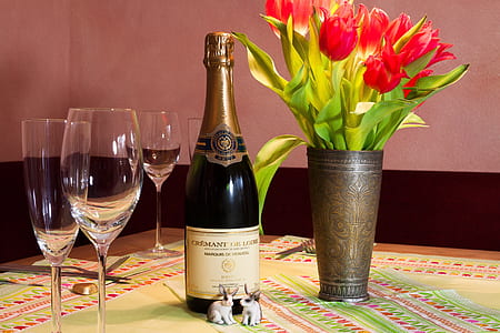 liquor bottle beside wine glasses thumbnail