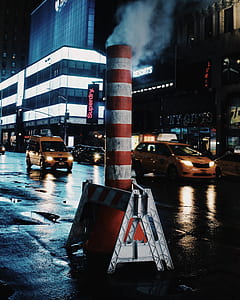 red and white metal pipe on road during nighttime thumbnail