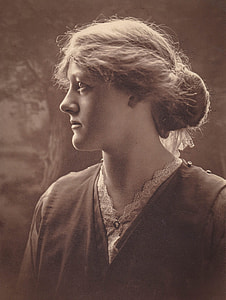 woman in black top looking at her right thumbnail