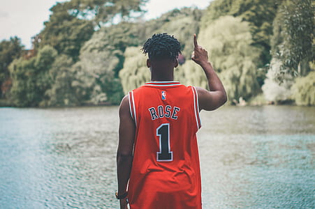 person wearing Derick Rose jersey standing near body of water thumbnail