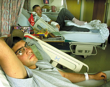 two men lying on hospital bed thumbnail