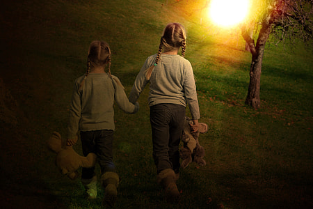 two girls walking near tree thumbnail