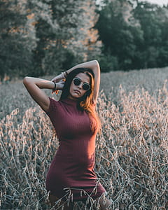 woman stand on field over trees at daytime thumbnail