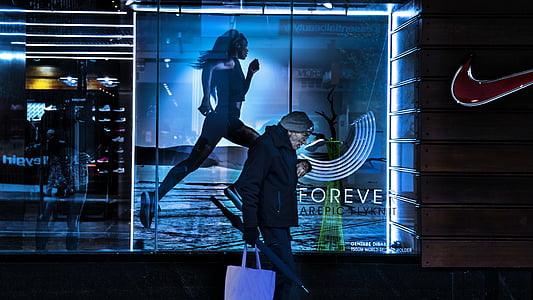 person standing near store front during night time thumbnail