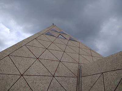 gray concrete building under cloudy sky during daytime thumbnail