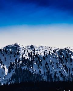snow covered mountain under blue sky thumbnail