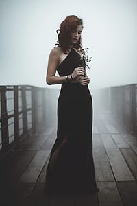 woman posing while holding flowers thumbnail