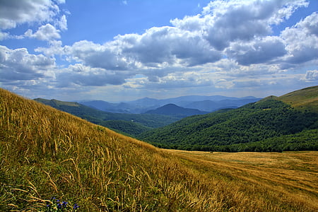 green mountain under white clouds and blue sky at daytime thumbnail