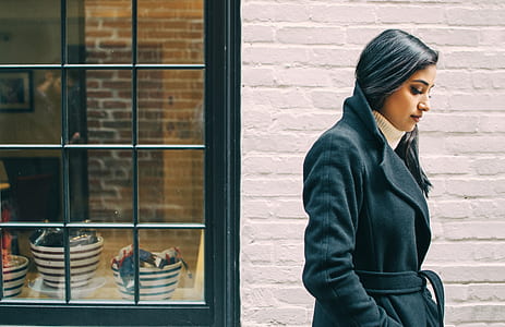 woman wearing black coat looking down thumbnail