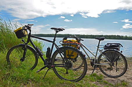 black and white bicycles beside body of water thumbnail