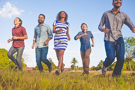 five people running on grassy field thumbnail