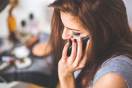 woman wearing gray shirt using phone thumbnail