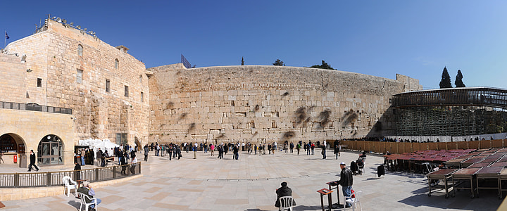 crowd of people standing beside brown concrete building thumbnail