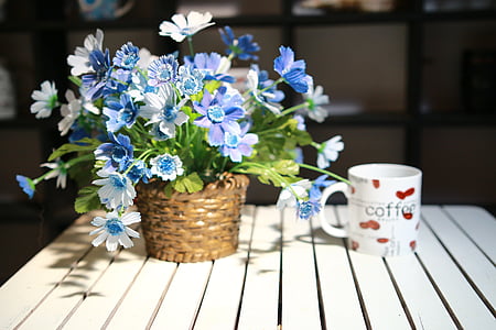 white and red coffee-printed ceramic mug near flower decor thumbnail