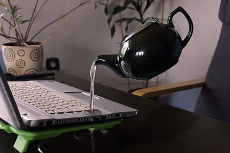 White Kettle Droping Water on Silver Laptop Computer thumbnail