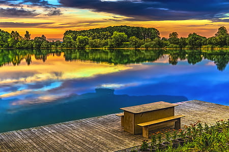 rectangular brown wooden desk near water thumbnail