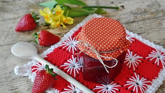 strawberry jam in clear bottle with three strawberry fruits beside thumbnail