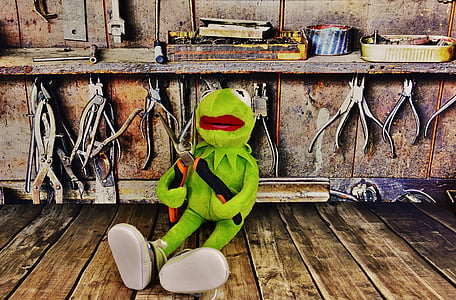 Kermit the Frog plush toy sitting on brown parquet floor thumbnail