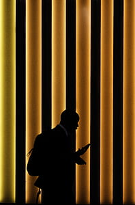 silhouette of a man holding a phone thumbnail