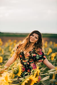 woman standing in sunflower field thumbnail